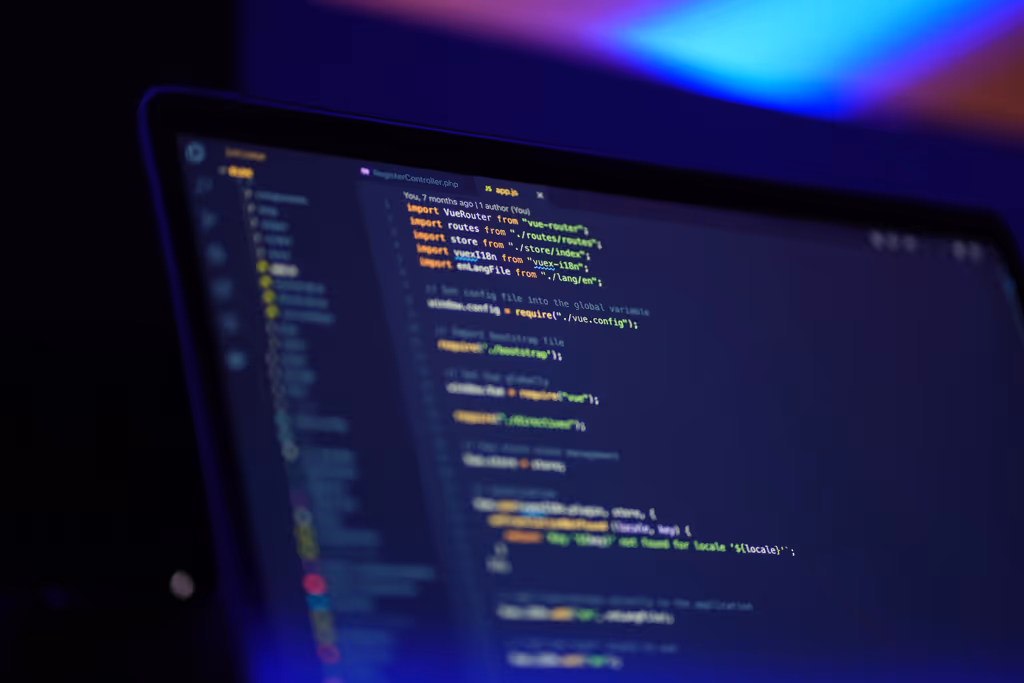 A darkened scene featuring an IDE on a MacBook Pro, representing web development.